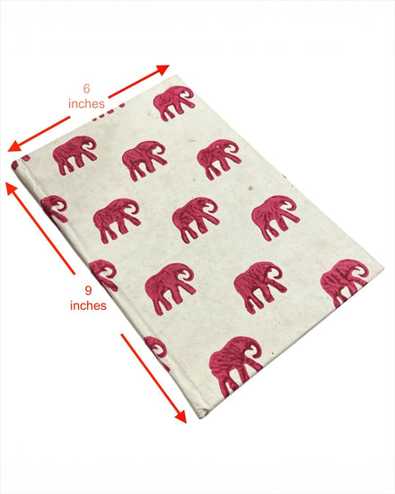 Bombay Paperie handcrafted 6x9 inch notebook featuring a cream cover with vibrant pink block-printed elephant motifs.