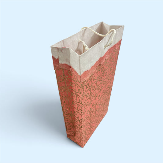 Bombay Paperie handmade red and pink paper gift bag with gold-foiled patterns and rustic deckled-edge finish