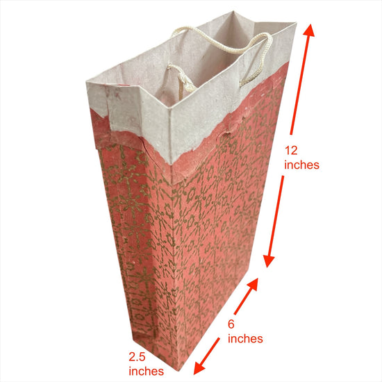 Bombay Paperie handmade paper gift bag in red and pink with gold-foiled patterns and deckled-edge top